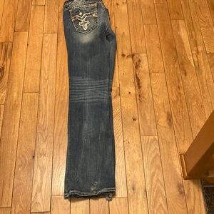 Women’s size 31 waist by 35 inseam. Stonewashed Jeans with Embellished Pockets.